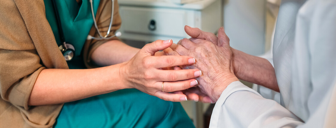 Doctor giving encouragement to elderly patient