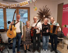 Musikgruppe mit Instrumenten feiert Bauernsilvester unter „New Year 2026“-Deko